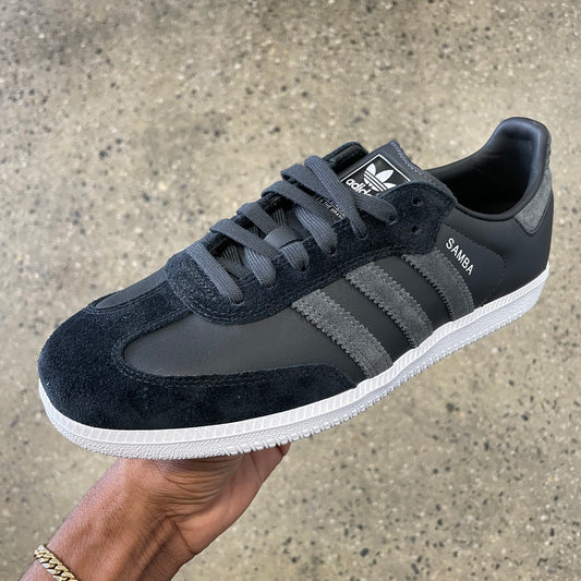black leather and suede sneaker with grey stripes and white sole, side view