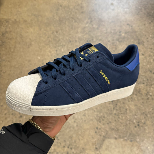 blue suede sneaker with white sole and toe, side view