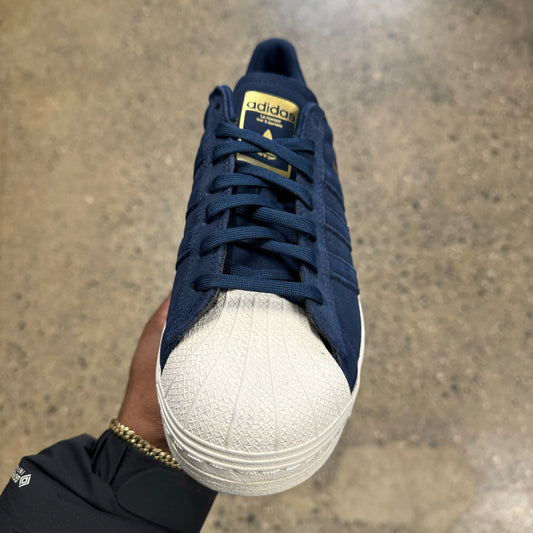 blue suede sneaker with white sole and toe, front view