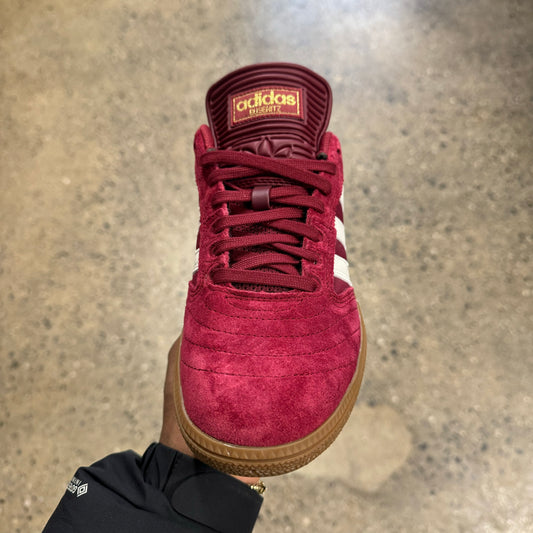 burgundy suede sneaker with gold logo, front view