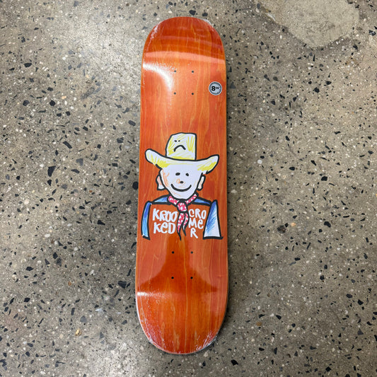 drawing of cowboy on orange wood grain skate deck (wood grain colors may vary)