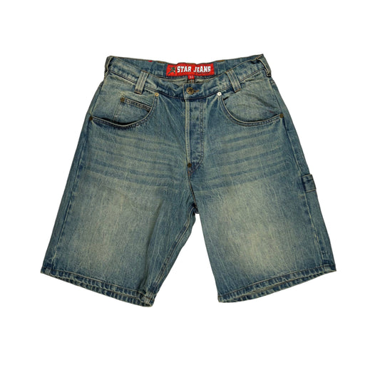 Blue denim shorts with a brand label on a gray surface
