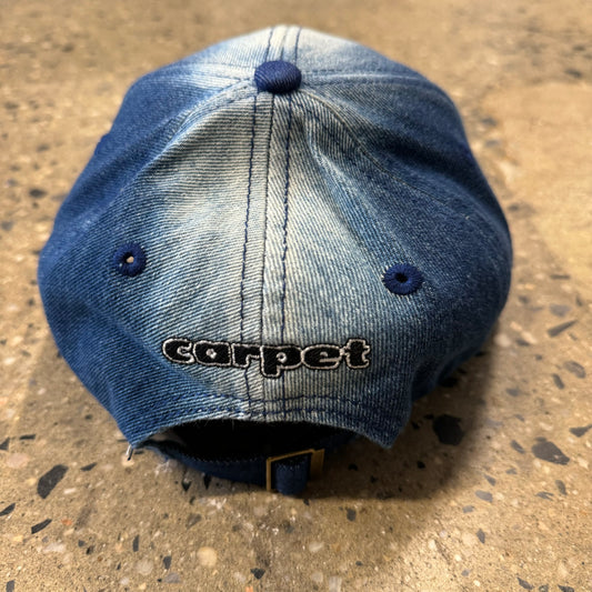 Rear view of bleached denim hat with carpet logo