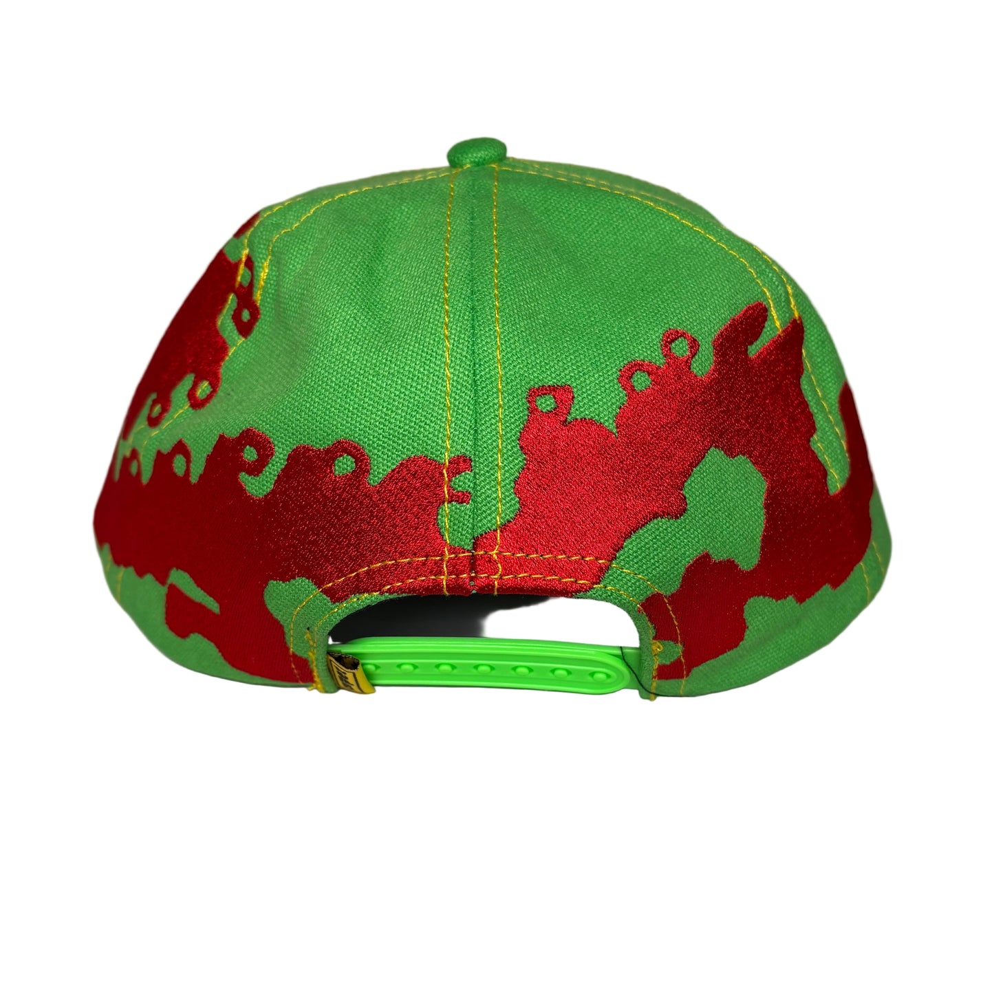 rear view of Green and red dragon-patterned cap on a white surface