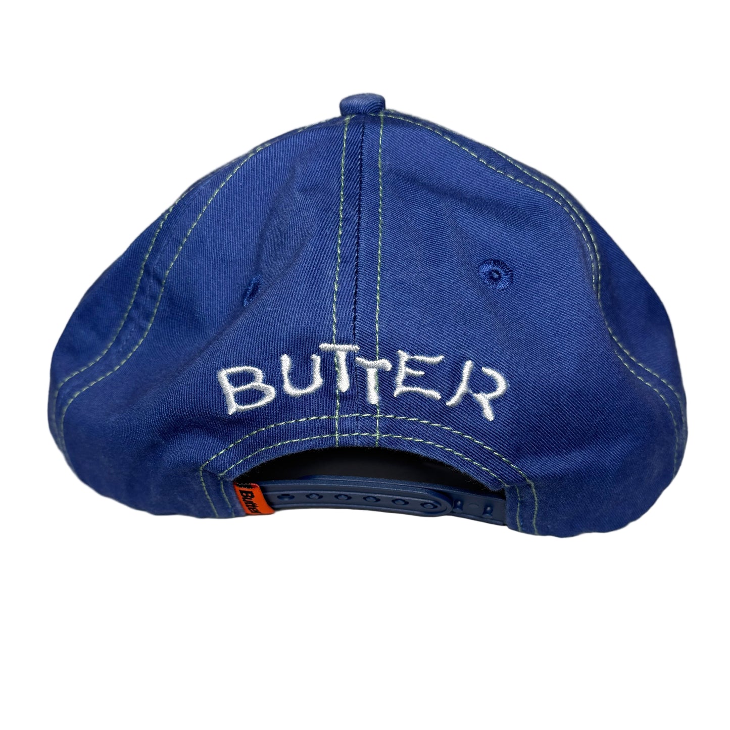 Blue cap with 'BUTTER' branding on a white background