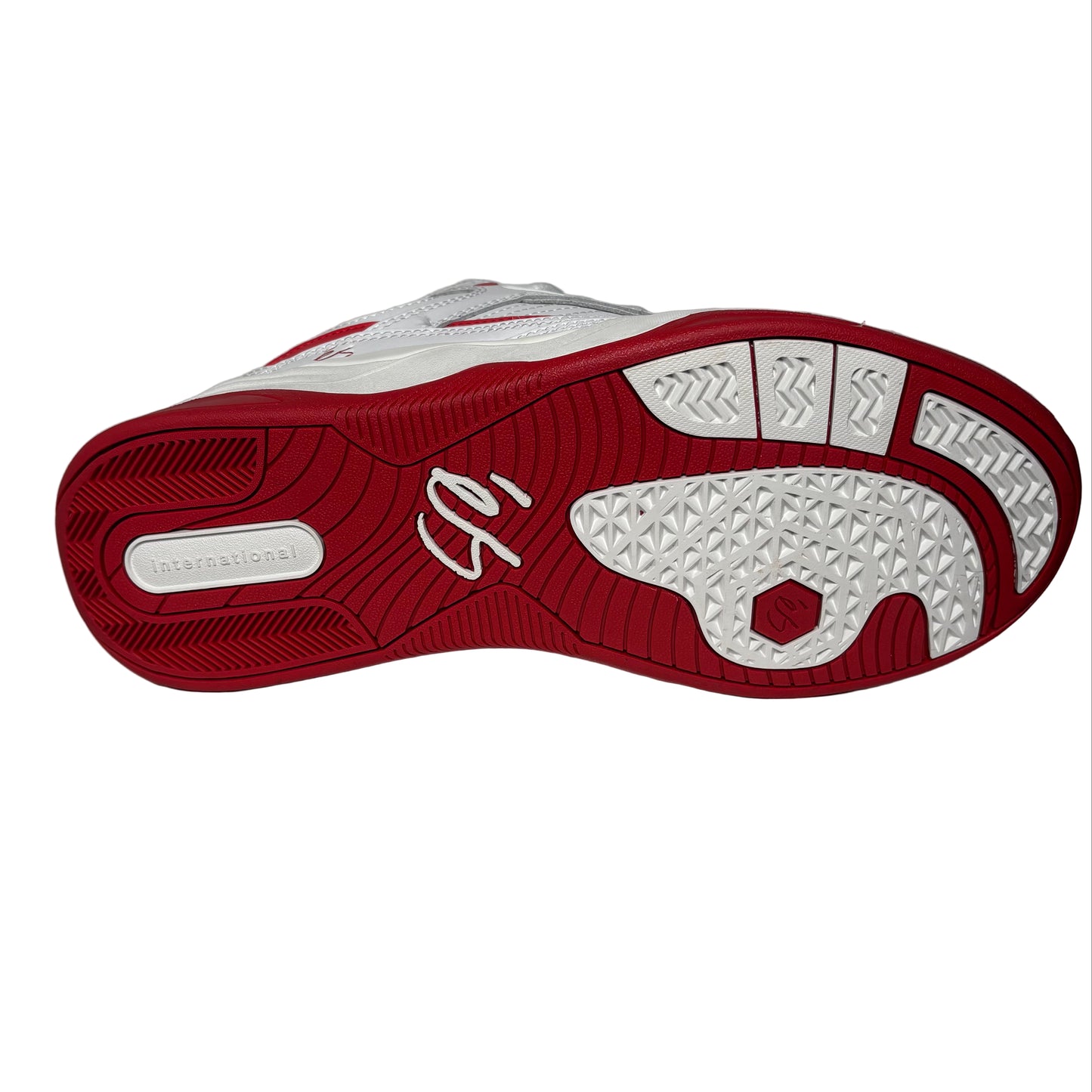 Red and white sneaker sole on a gray background