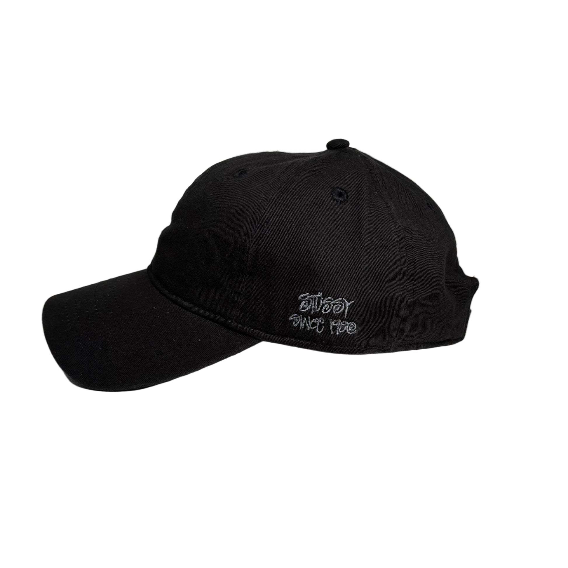 Black cap with white stussy text on a white background