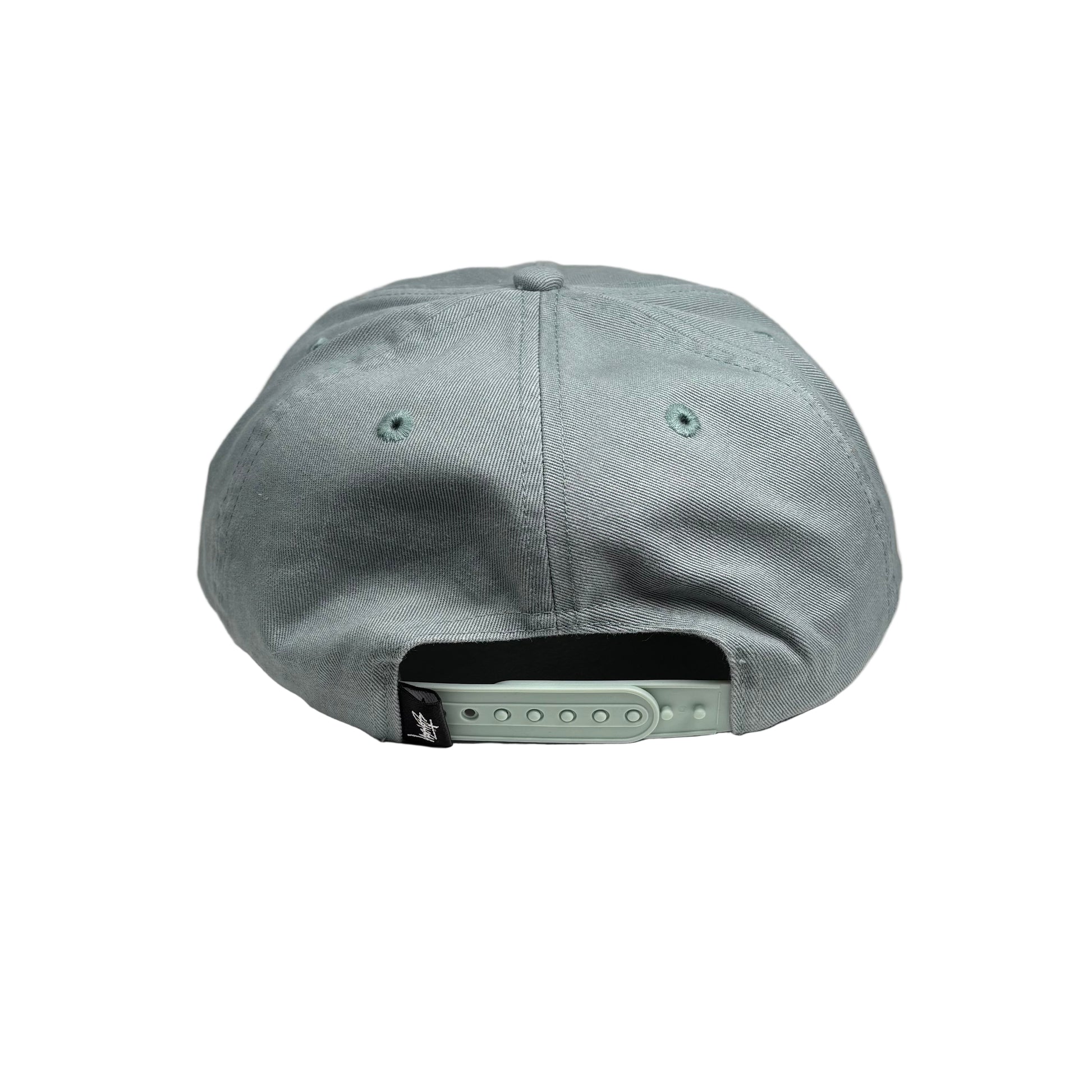 sea green cap on a white pedestal background