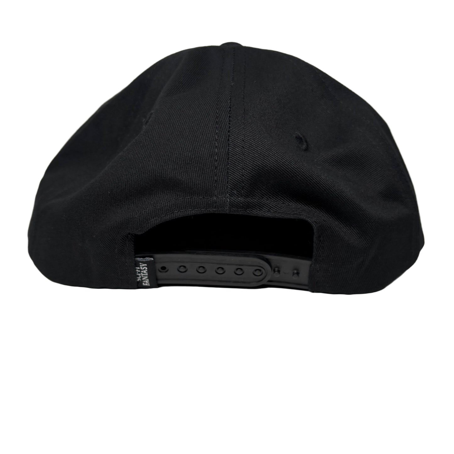 Black cap on a white surface with a gray background