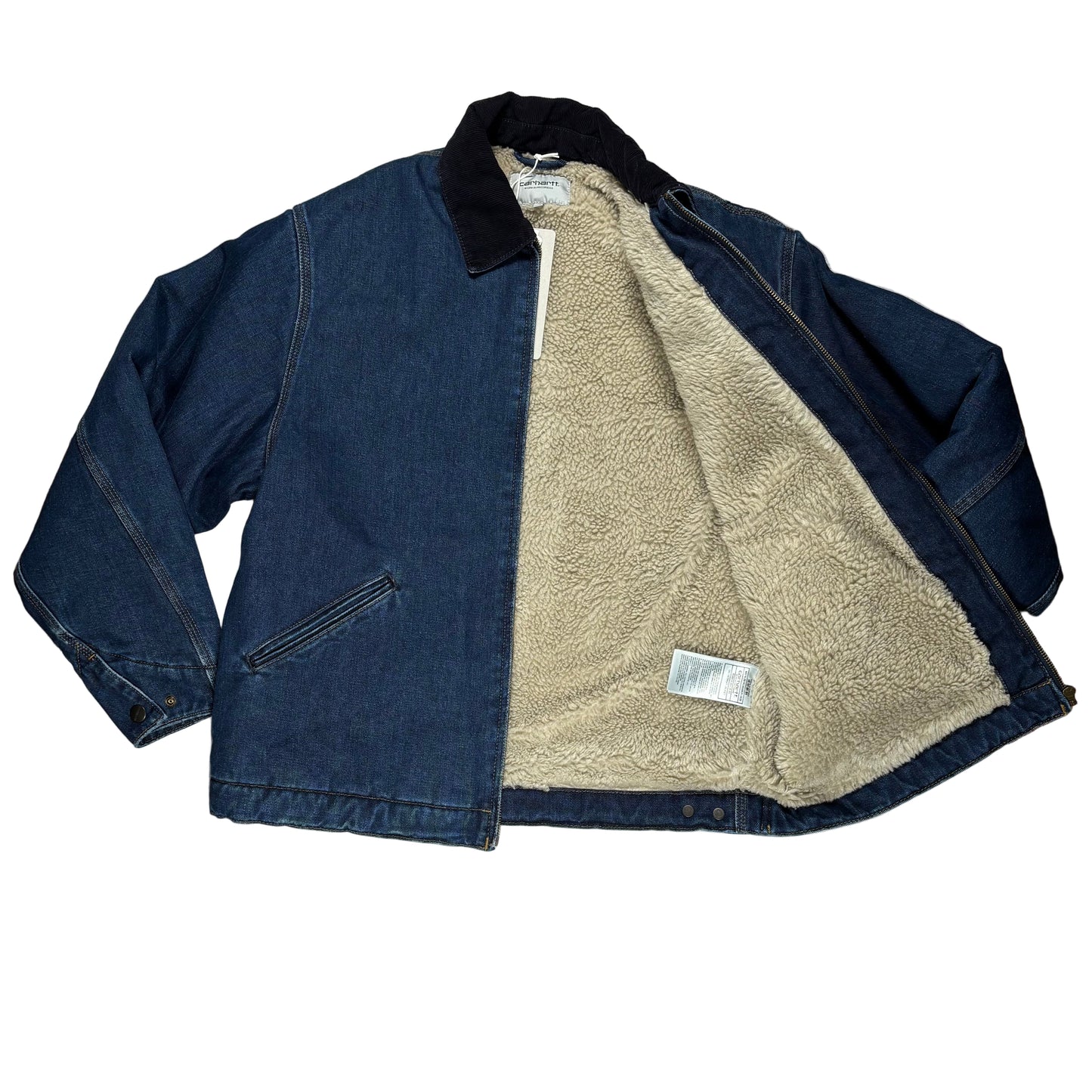 Blue denim jacket with beige fleece lining on a white surface