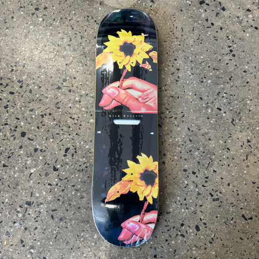hands with sunflowers on black skate deck
