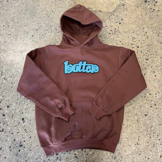 blue and black Butter logo on brown hoodie