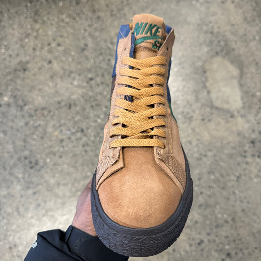 top down view of tan, navy and green mid top shoe
