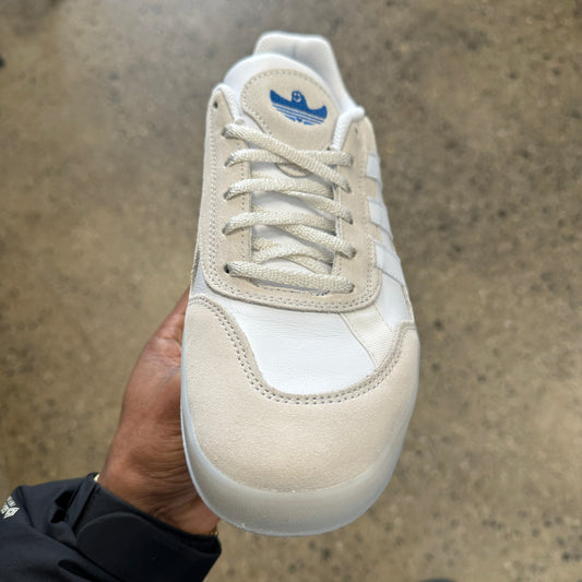 white leather and suede sneaker, blue logo, front view