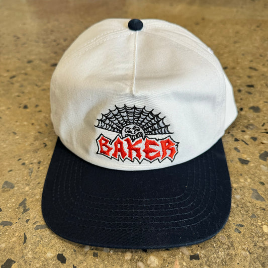 white hat with black spider web, red Baker logo, and black bill