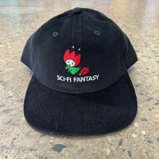 black corduroy hat with rose character riding on flower with logo