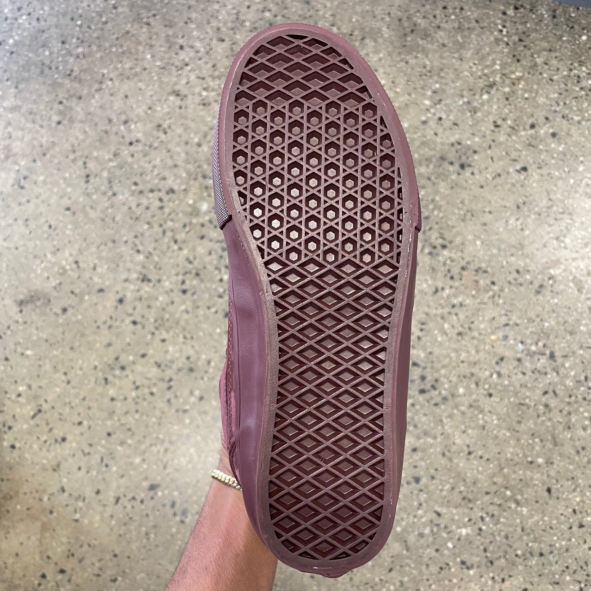 bottom view of brick red gum rubber outsole on skateboard shoe