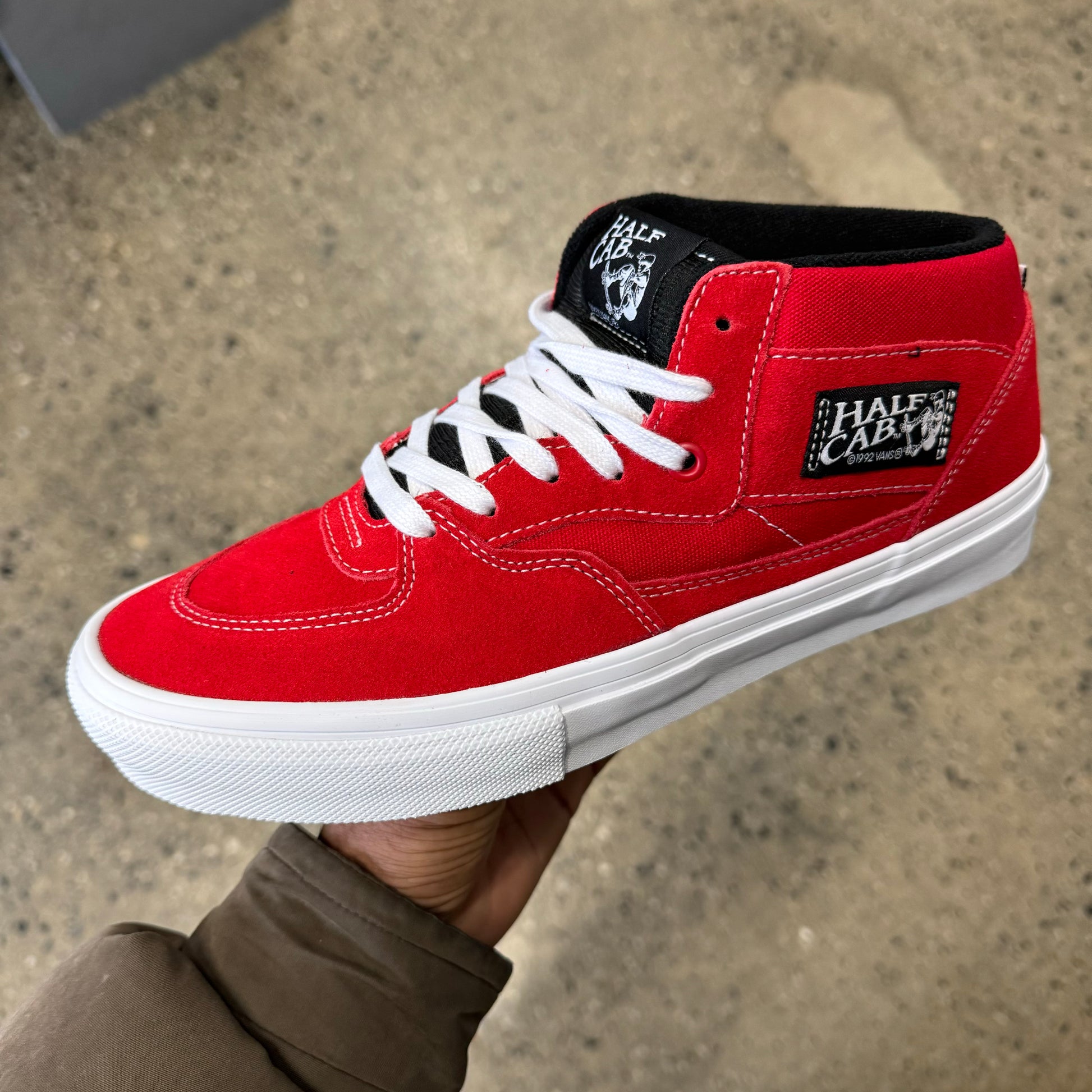 Red suede and canvas mid top skateboard shoe with black tounge, and white outsole