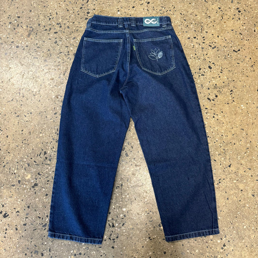 back view of blue denim jeans, white stitch pockets and logo on back pocket