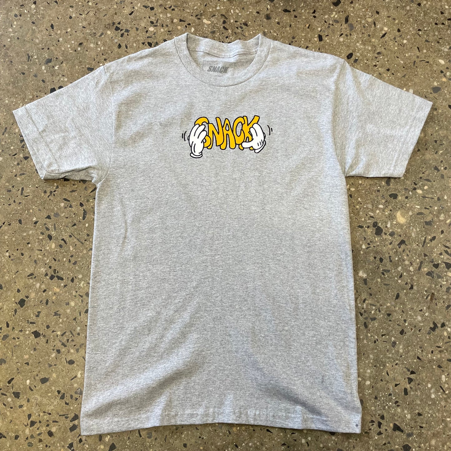 yellow logo on grey T-shirt