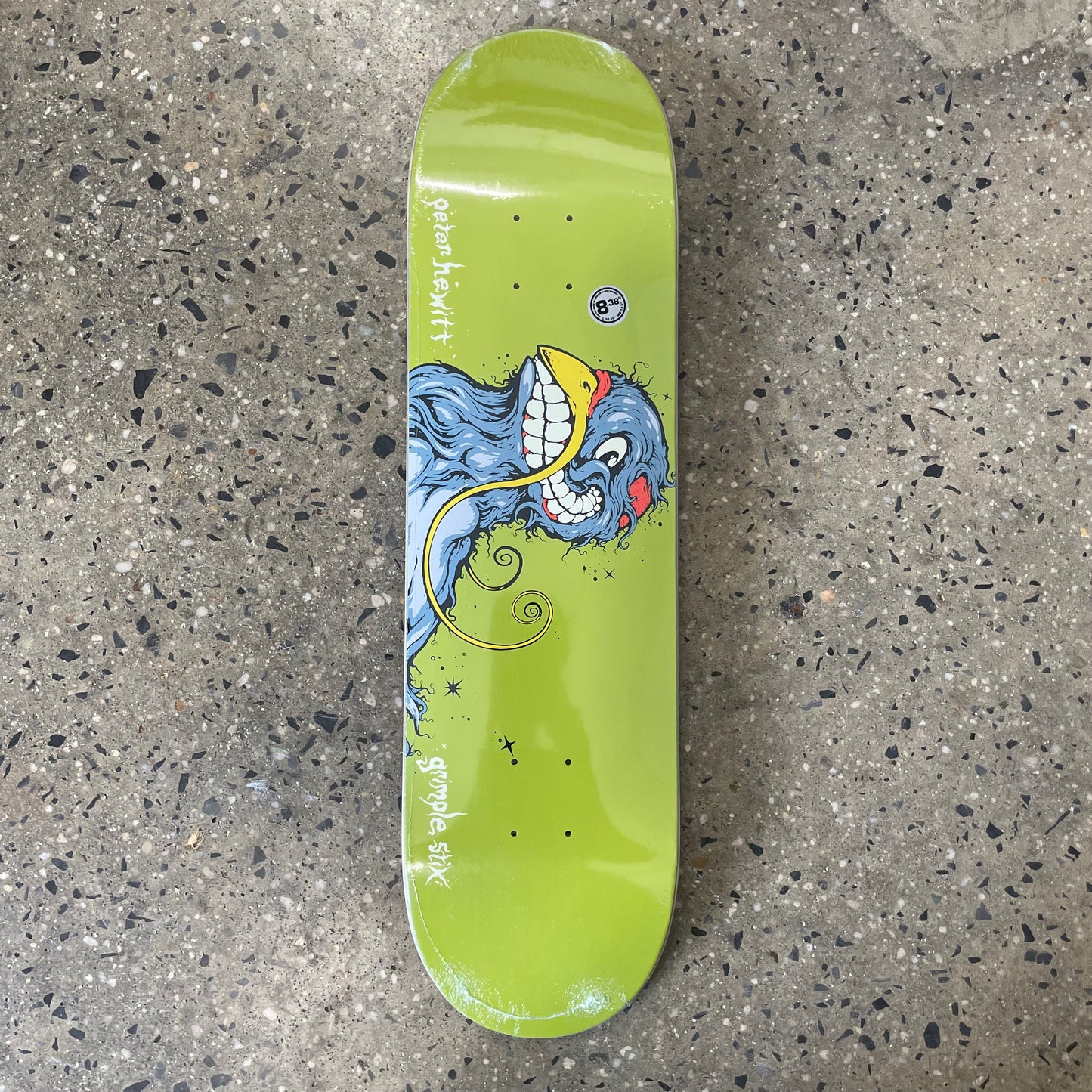 deranged looking pigeon on green skate deck