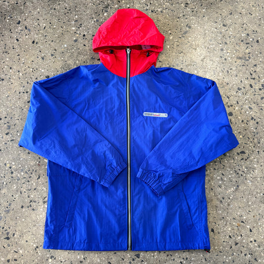 Front view of royal blue nylon zip jacket with red hood