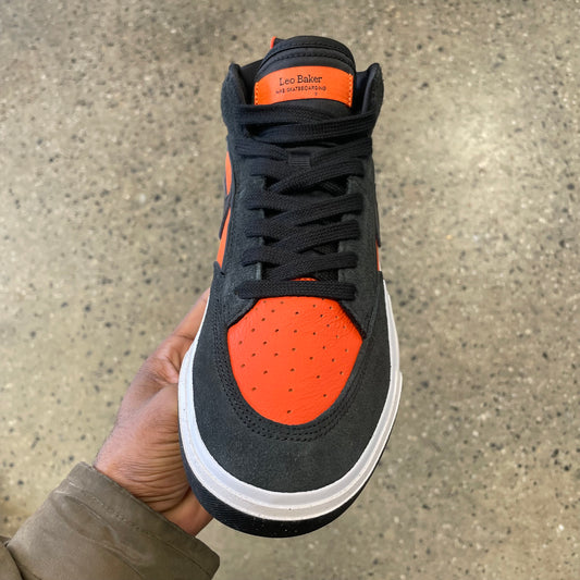 top down view of black and orange suede and leather skate sneaker