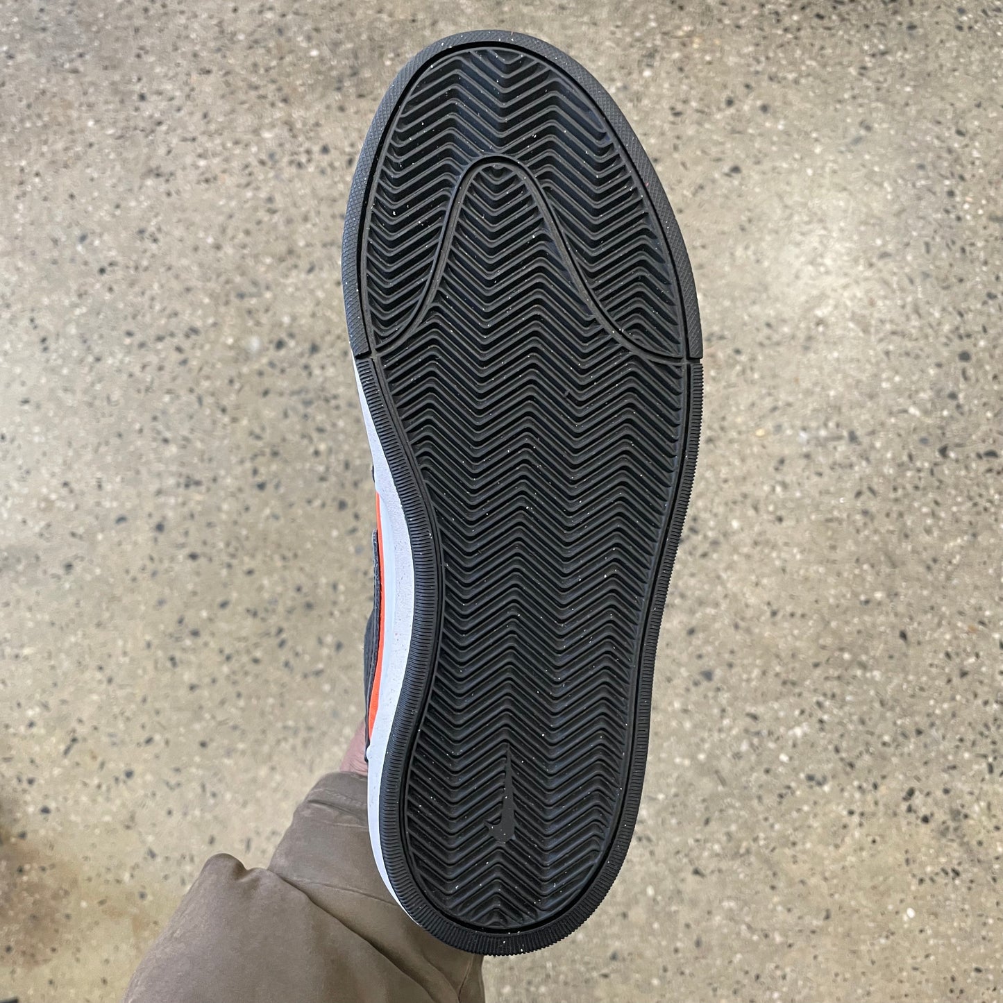 view of black gum rubber bottom of skate sneaker