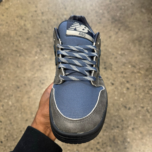 grey and blue sneaker with black sole, front view