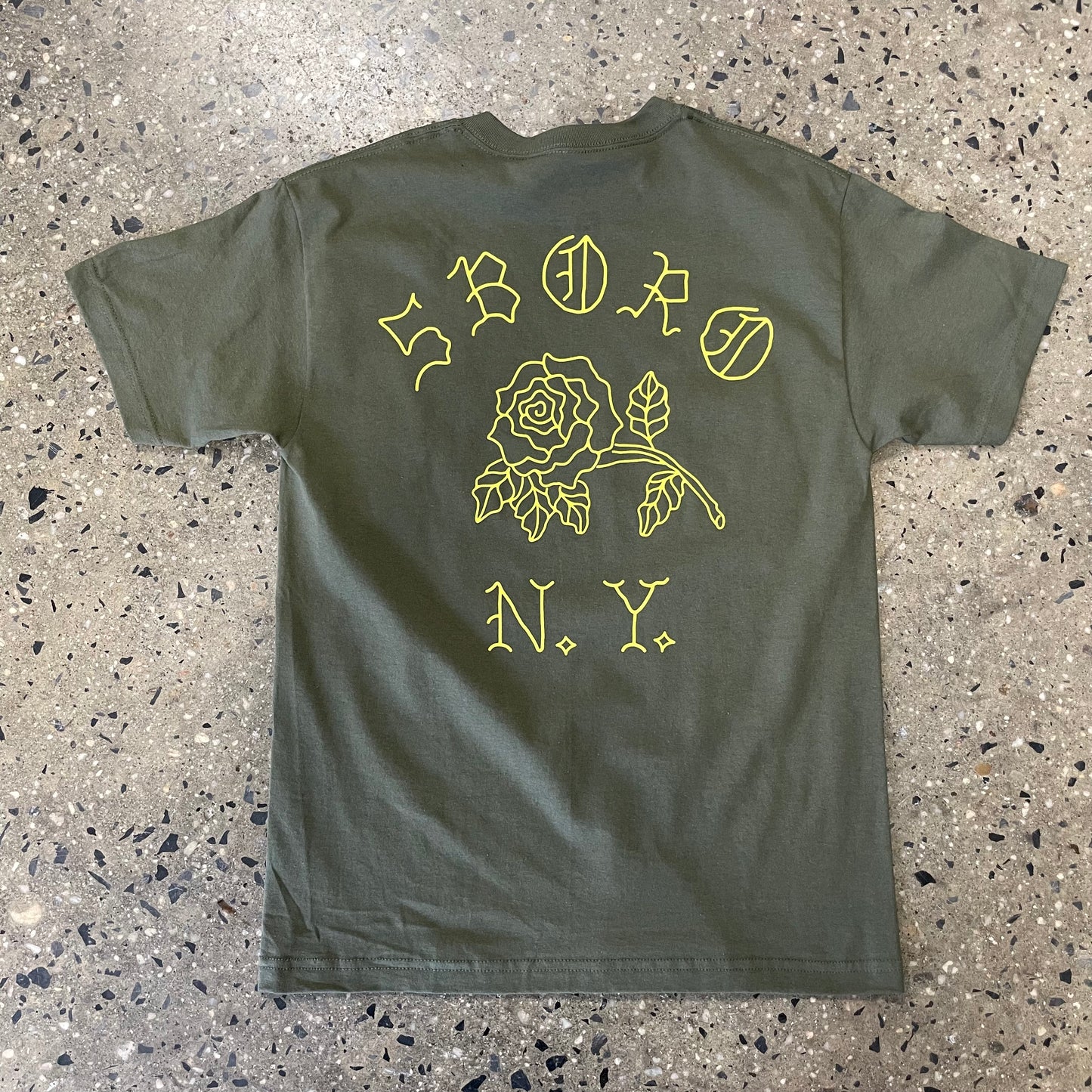 Large arch style back print with 5boro, a rose in the middle, and NY on the bottom line, yellow ink on an olive t-shirt