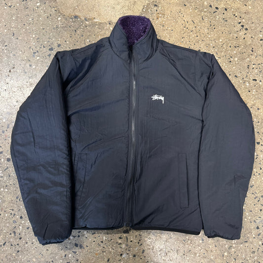 front view of reversed black nylon stussy sherpa jacket