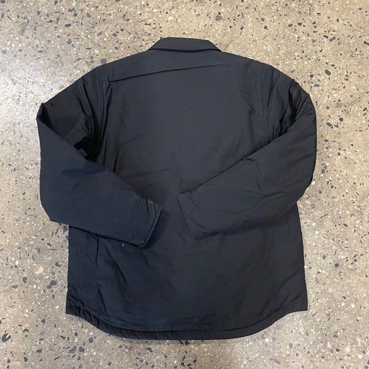 rear view of snap closure padded tech overshirt