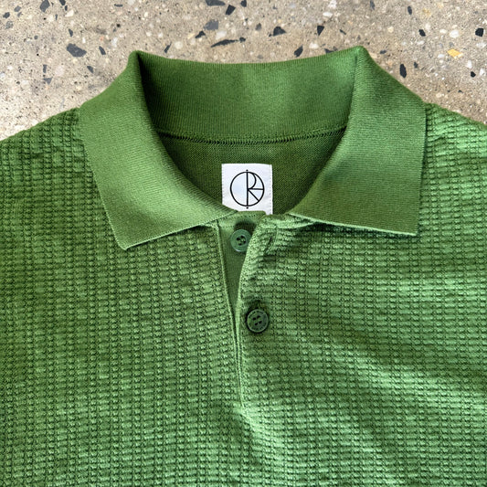 closeup of collar, knit, and green buttons