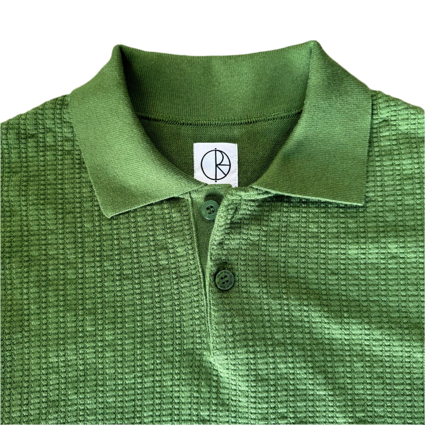 closeup of collar, knit, and green buttons