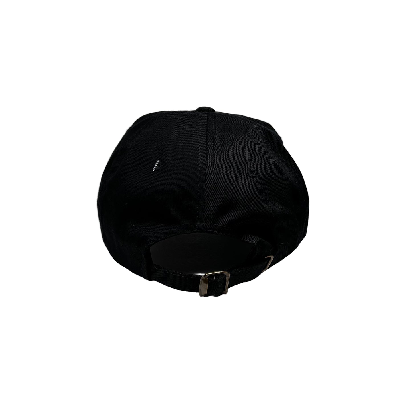 Black cap on a white pedestal against a white wall