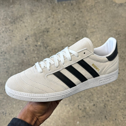 white suede sneaker with black stripes and white sole, side view
