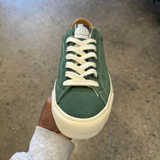 green suede sneaker with white sole and stitch, front view