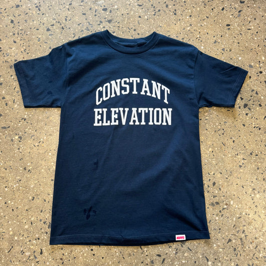 White Constant Elevation written on navy t-shirt