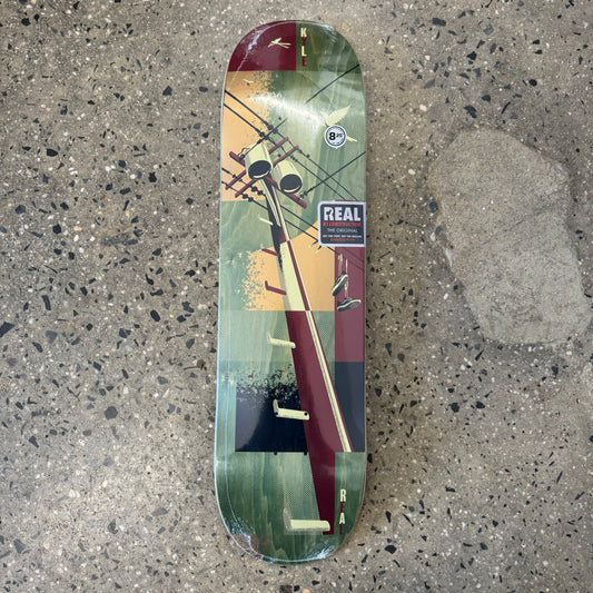brown, green, yellow abstract design on skate deck