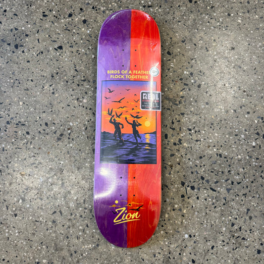 people in water with birds in sky on purple and red wood grain skate deck (wood grain color may vary)