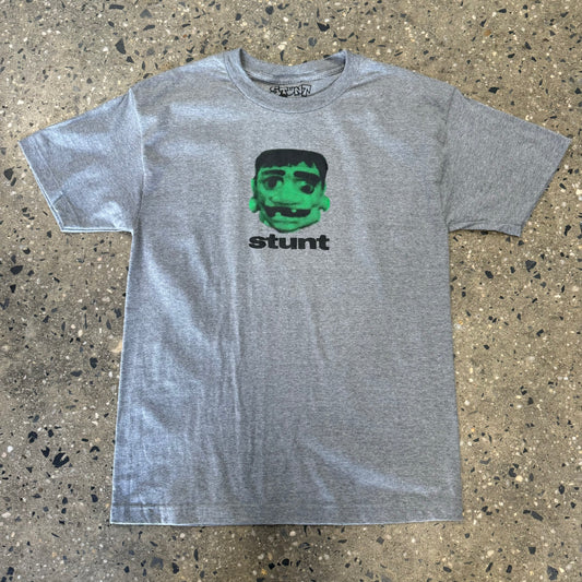 Green and black stunt head printed on athletic grey t-shirt