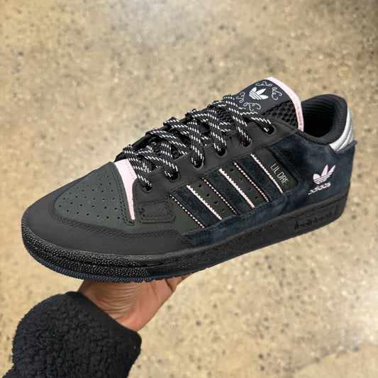 black suede sneaker with pink logo, side view
