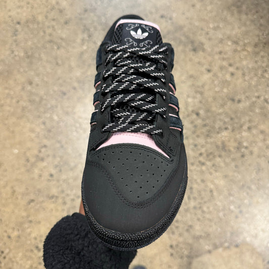 black suede sneaker with pink logo, front view