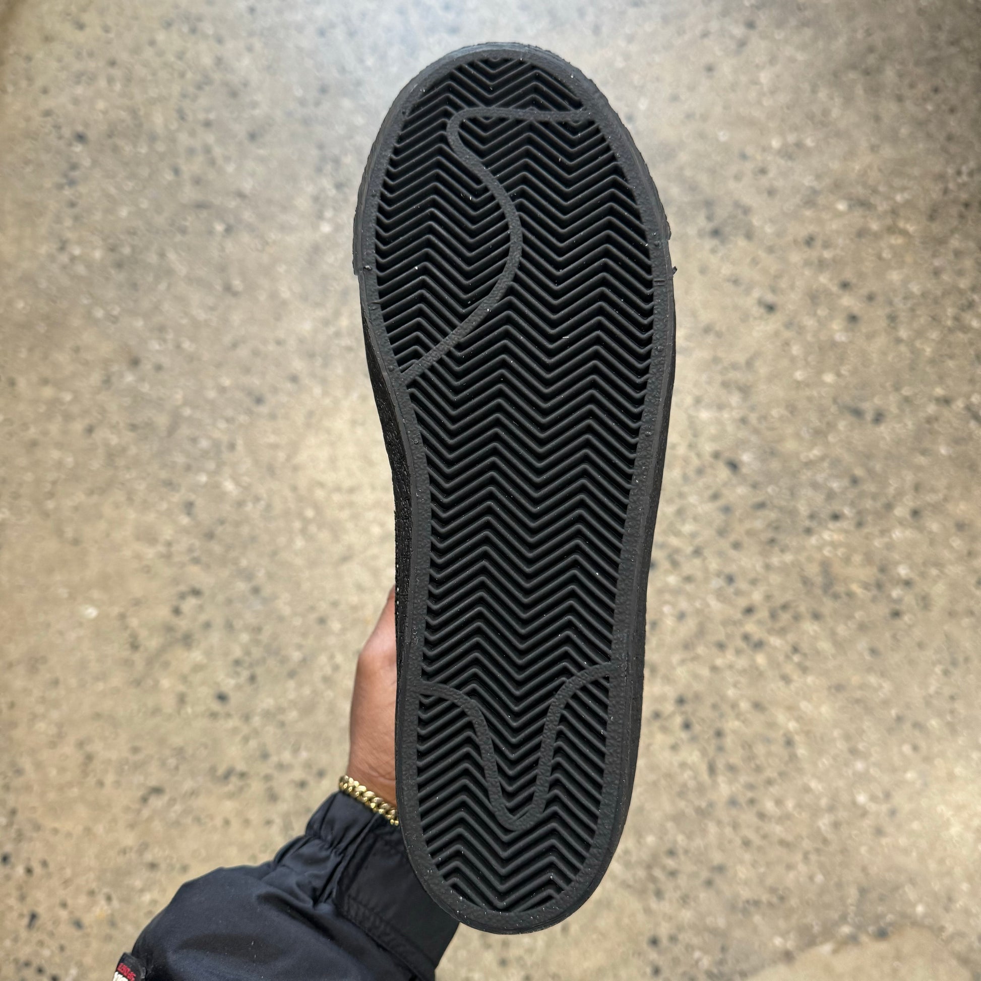 view of black gum rubber outsole of shoe