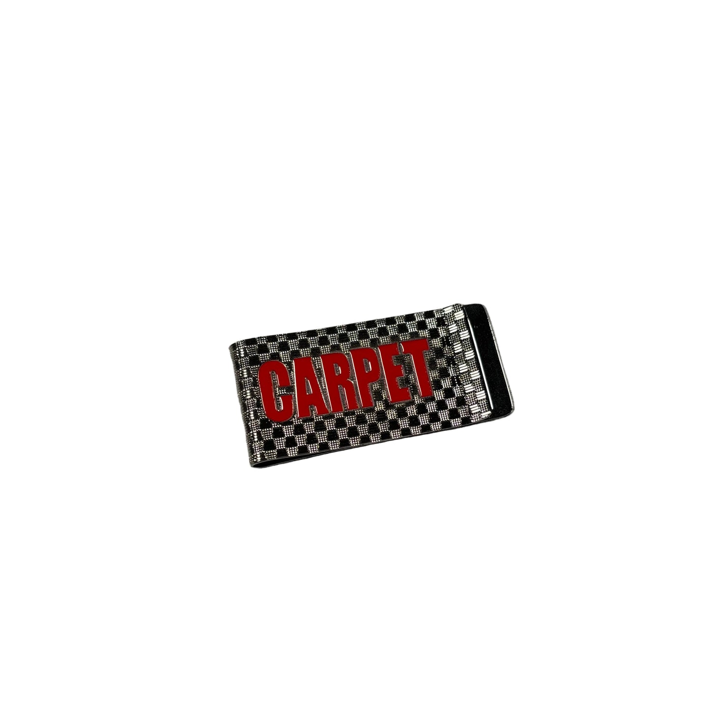 Metal money clip with 'CARPET' text on a checkered pattern against a white concrete background