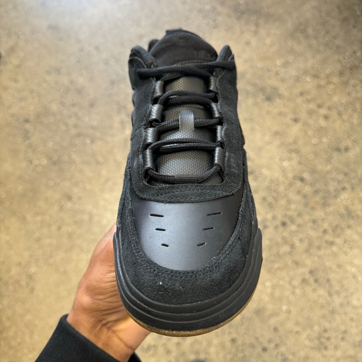 top down view of black suede and leather skateboard sneaker