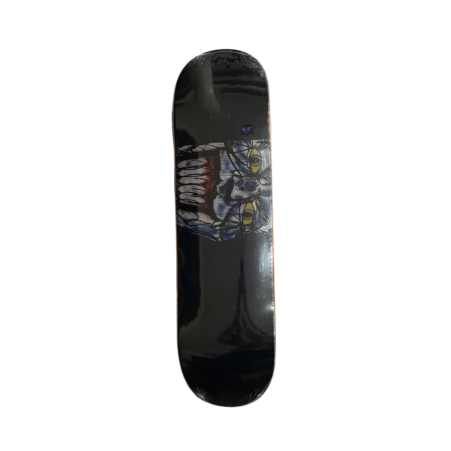 Skateboard deck with a joker graphic design on a white surface
