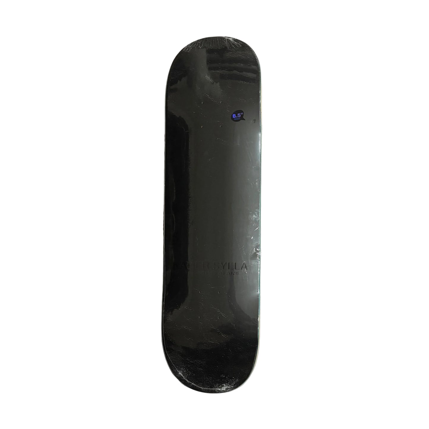 Black skateboard deck on a white surface