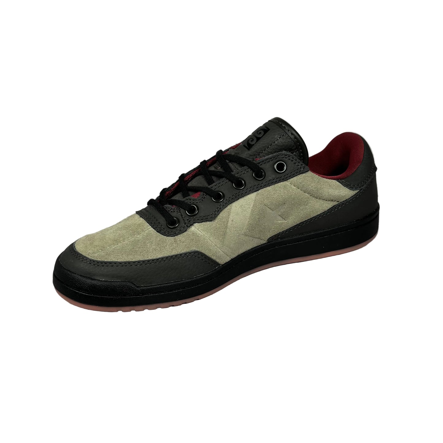 Suede sneaker with black and red accents on a white background