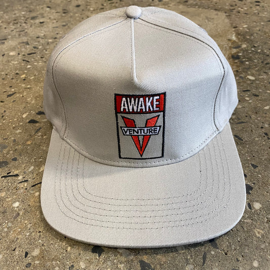 Grey and red VENTURE V AWAKE logo embroidered on light grey snapback hat, front view